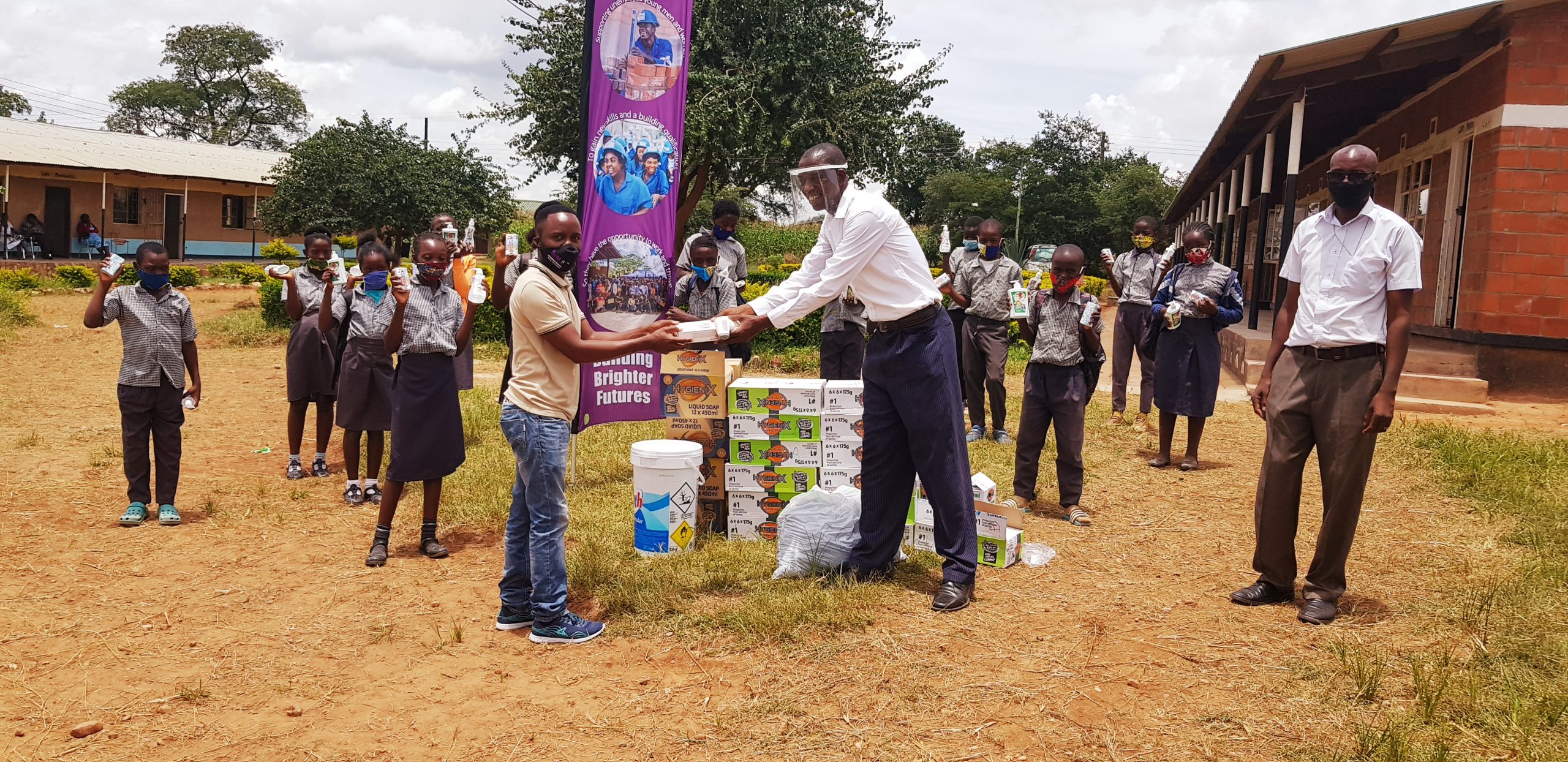 PPE supplies being presented to Head Teacher for Bissell Community Mr Sebastián Mundando