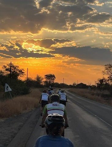Cyclists riding into camp watching out for elephants