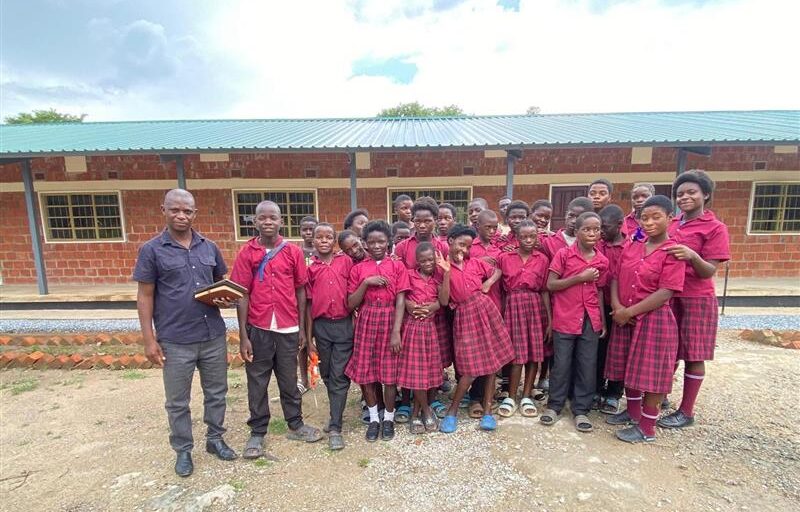 Head teacher Mr Mumba with his pupils 