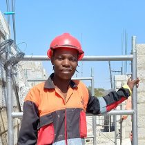 Build It graduate Evelyn Malunga working onsite